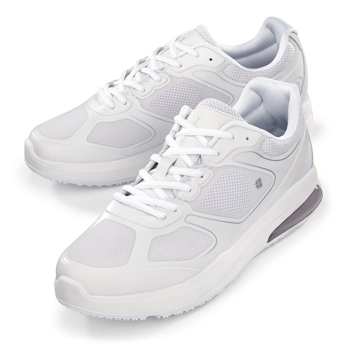 The Evolution II White from Shoes For Crews are slip-resistant and water-resistant trainers, pair seen from the left side, emphasised on the tip of the left  shoe.