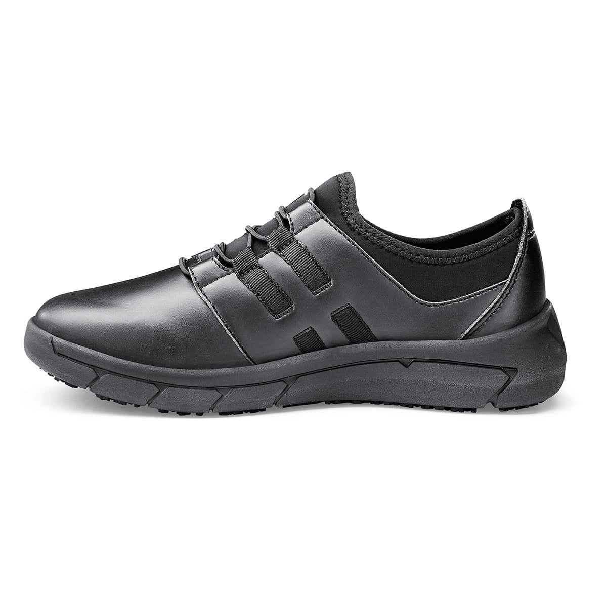 The Karina Black by Lila from Shoes For Crews are black slip-resistant trainers that are lightweight and have Flex Tread technology, seen from the left.