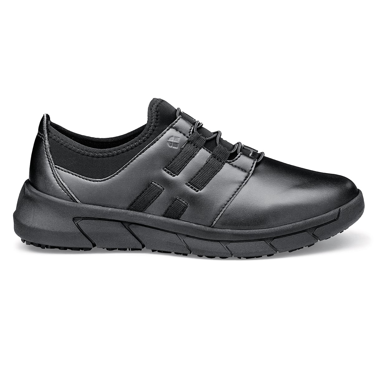 The Karina Black by Lila from Shoes For Crews are black slip-resistant trainers that are lightweight and have Flex Tread technology, seen from the right.