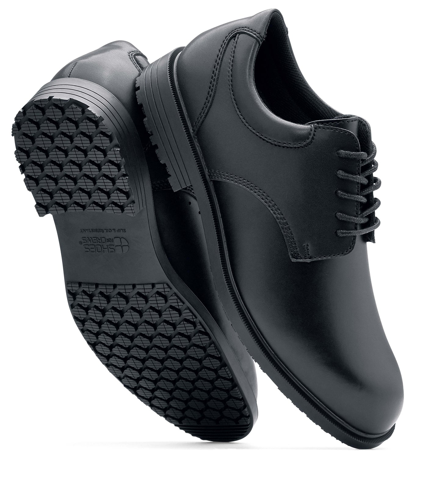 The Shoes for Crews Cambridge III is a slip-resistant leather dress shoe, with removable cushioned insoles and a padded comfort collar, pair viewed vertically, with a focus on the sole and side.