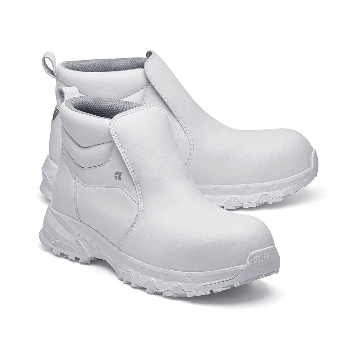 The Inny from Shoes For Crews is a safety shoe with a slip-resistant, clog-resistant upper sole and our advanced TripGuard technology, pair seen from the right side, emphasised on the tip of the right shoe.