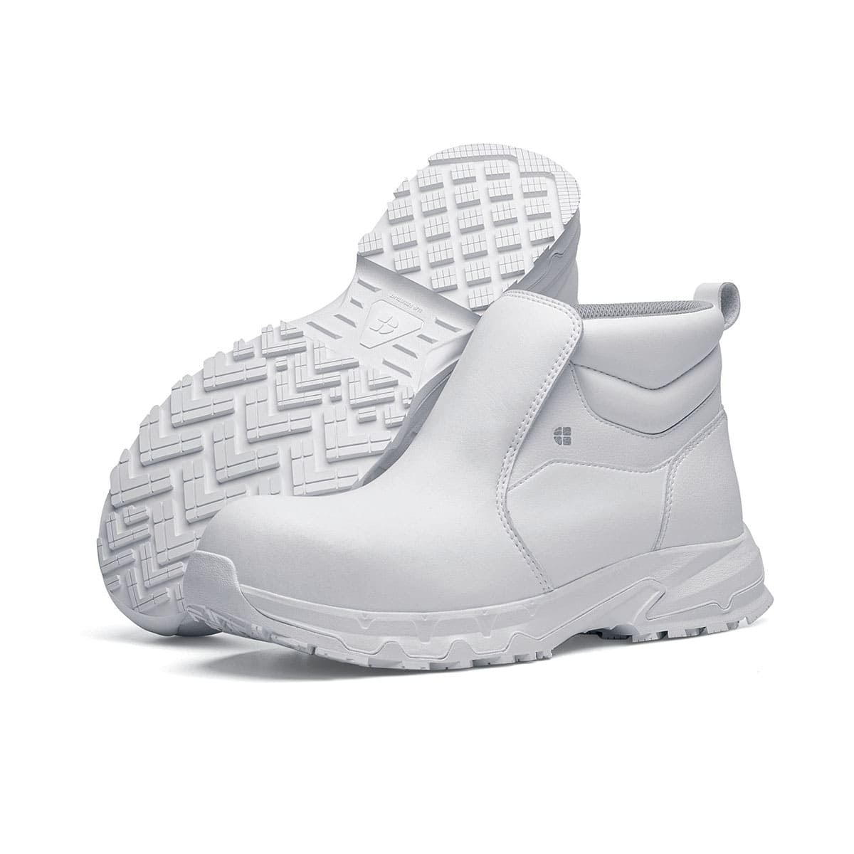 The Inny from Shoes For Crews is a safety shoe with a slip-resistant, clog-resistant upper sole and our advanced TripGuard technology, pair seen from the left side and the sole.