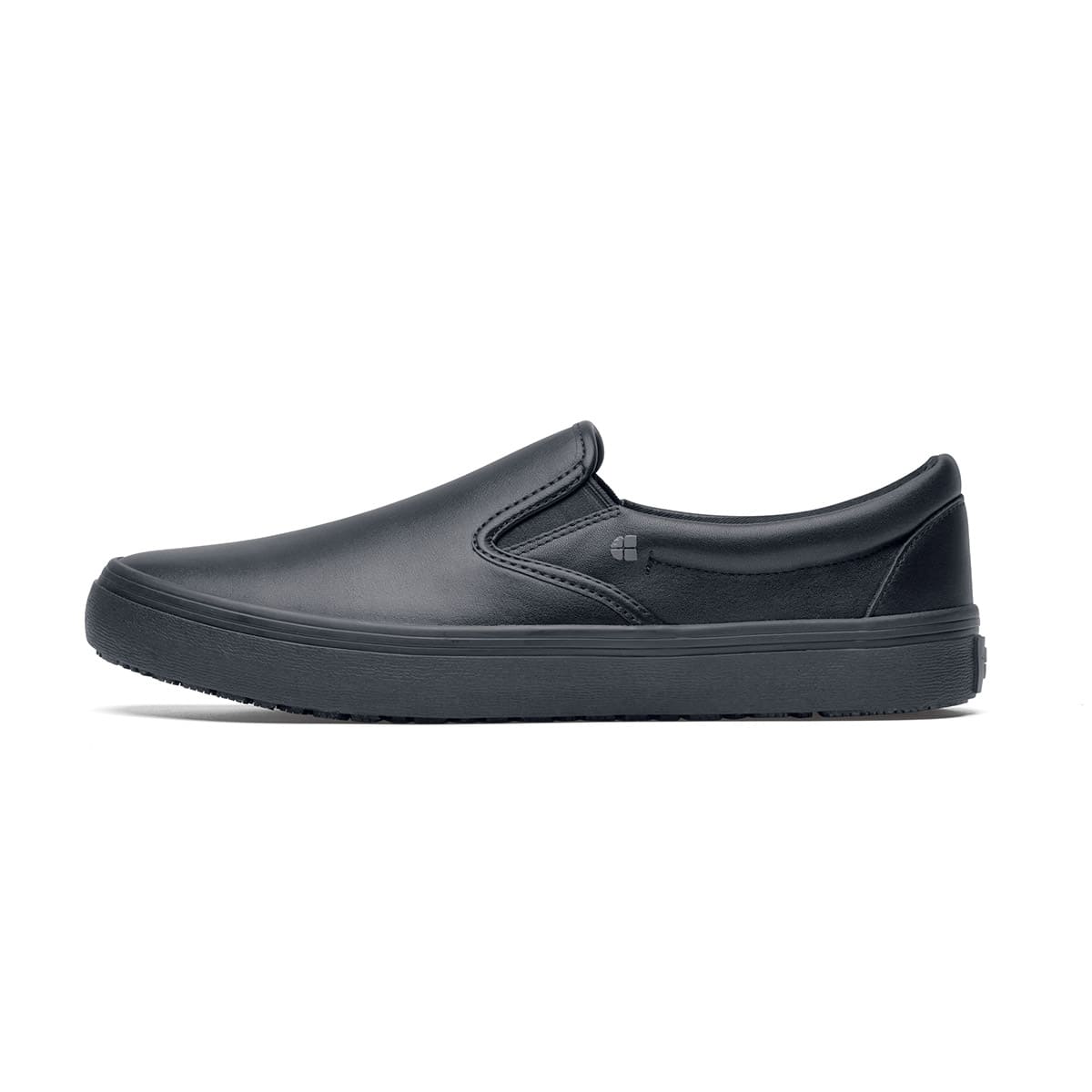 The Merlin Black from Shoes For Crews are slip-on slip resistant shoes with a lightweight design and constructed from genuine leather that has been specially treated to repel liquids from the surface, seen from the left.