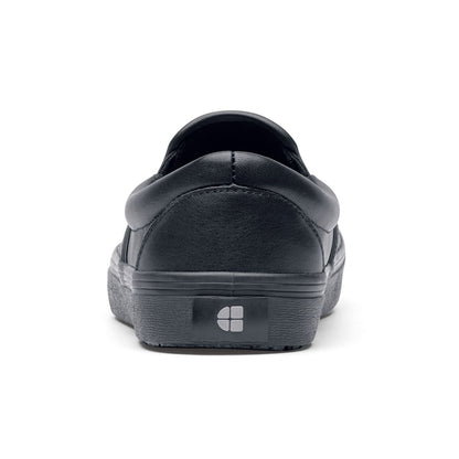 The Merlin Black from Shoes For Crews are slip-on slip resistant shoes with a lightweight design and constructed from genuine leather that has been specially treated to repel liquids from the surface, seen from the back.