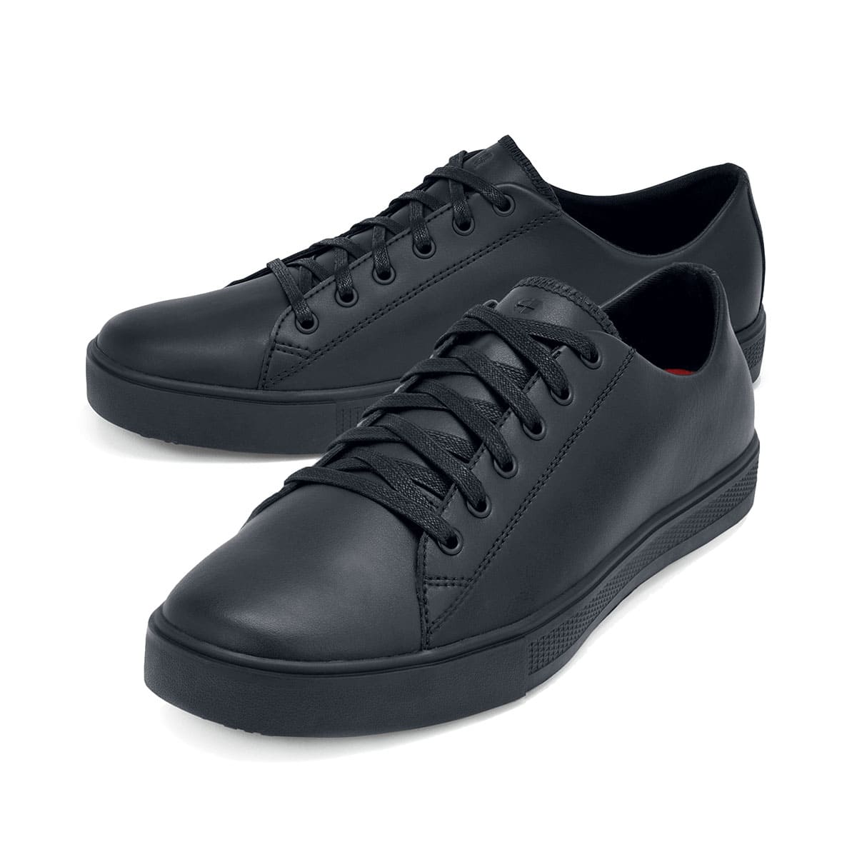 The Old School Low-Rider Black Gladiator Outsole from Shoes For Crews is a slip resistant lace-up shoe designed to provide comfort throughout the day, pair seen from the left side, emphasised on the tip of the left shoe.